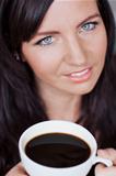 Beautiful woman enjoying cup of coffee