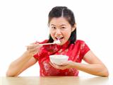 Asian woman eating rice