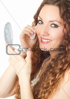 Portrait of  model female with long hair  having cosmetics with powder and brush on white background