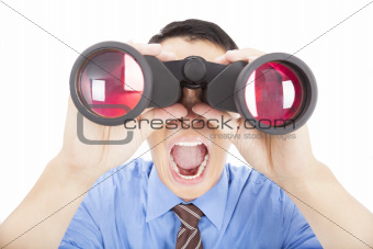 surprised businessman looks through binoculars and isolated
