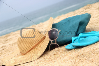 Blue beach bag on the seacoast and straw hat 