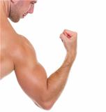 Closeup on muscular man showing biceps