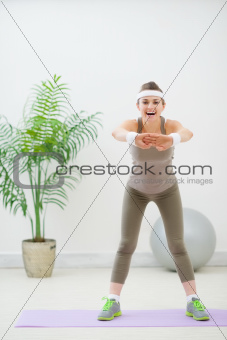 Portrait of slim young woman making fitness exercises