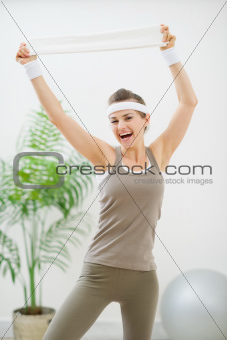Portrait of cheerful woman in sportswear with towel