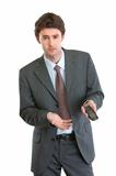 Unhappy businessman pointing on mobile phone