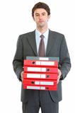 Modern businessman holding pack of folders