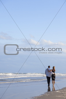 Romantic Man and Woman Couple Walking On A Beach
