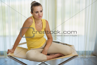 Thoughtful young woman sitting on chair