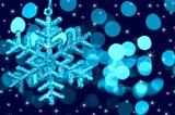 Christmas decoration snowflake  on defocused lights and stars ba