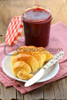 croissant with jam on a plate -  French breakfast