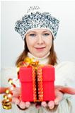 Attractive girl gives a wrapped gift