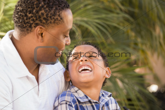Happy Mixed Race Father and Son Playing in the Park.