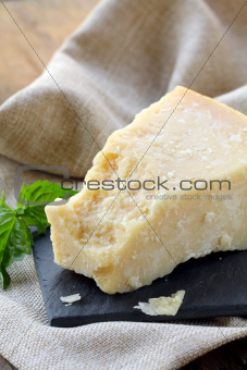 Parmesan cheese - hard Italian cheese on a wooden table