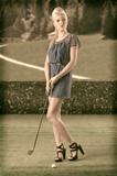 sexy blonde girl pays golf, looks at left in a vintage style