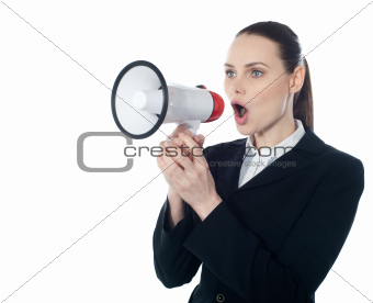 Business woman giving instructions with megaphone