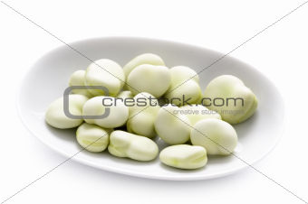broad beans in a white dish isolated
