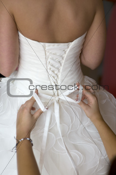 tying the bow on a wedding dress