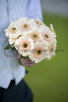 groom holding a wedding bouquet