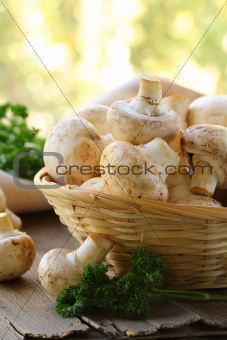 Fresh champignon mushrooms in a wicker basket