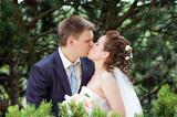 happy bride and groom kissing in nature