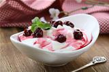 dairy dessert with sweet  sauce and cherries
