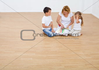 Kids and their mother choosing the color of their new home