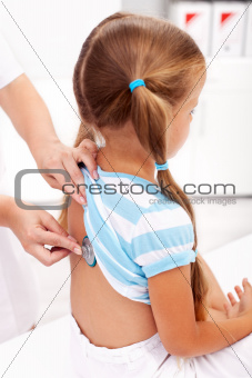 Little girl being checked at the doctor