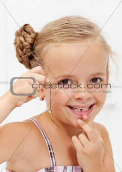 Little girl with her first missing milk tooth
