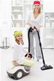 Woman and little girl cleaning the room