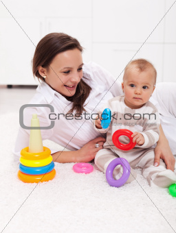 Baby girl and mother playing