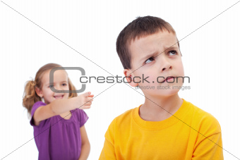 Bullying concept - girl mocking young boy