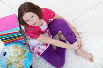 Young girl with school books and earth globe
