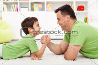 Father and son arm wrestling