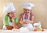 Kids preparing the dough for a cookie, pizza or pasta