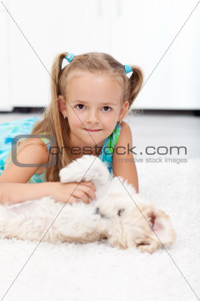 Little girl playing with her dog