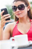Beautiful Young Woman Cell Phone Texting in Cafe