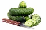  Fresh juicy cucumbers and knife for cutting vegetables.