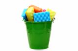 Bucket with colored sponges for cleaning.