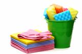 Cleaning cloths and bucket with colored sponges.