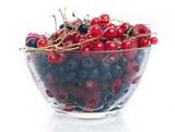 Fresh juicy various berries in glass bowl 