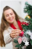 Closeup on female hand decorating Christmas tree