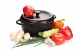 black cast-iron cauldron with vegetables