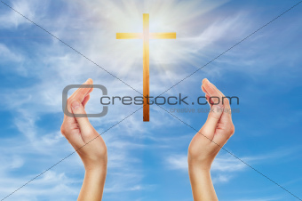 hands praying with a wooden cross