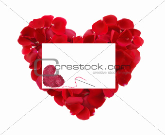 beautiful heart of red rose petals and greeting card with textil