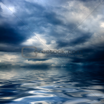 dark cloudy stormy sky with clouds and waves in the sea