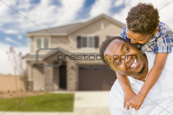 Happy Playful African American Father and Mixed Race Son In Front of House.