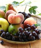 various autumn fruits (pears, apples, peaches and grapes)