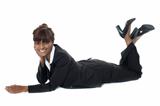Corporate woman lying on floor, smiling