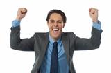 Excited businessman rasing his arms and cheering joyfully