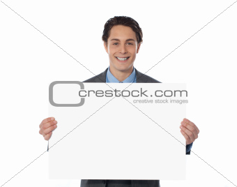 Happy businessman showing an emty billboard